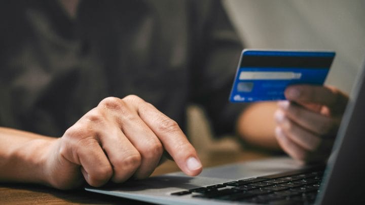 Person using Credit Card at Laptop
